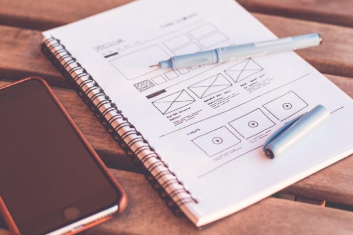 A notebook of an UX designer with wireframes