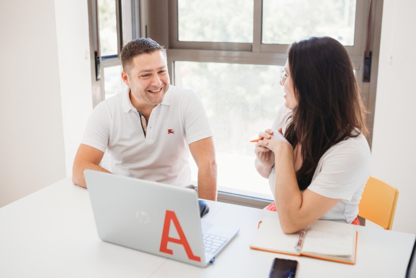 two coworkers talking in a meeting